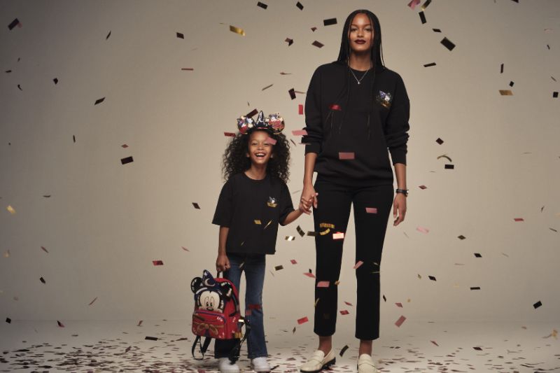 models pose with confetti to show Macy's x Disney adult and child merchandise 