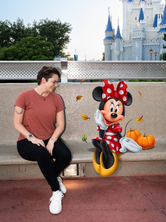 Minnie poses beside pumpkins in photopass magic shot