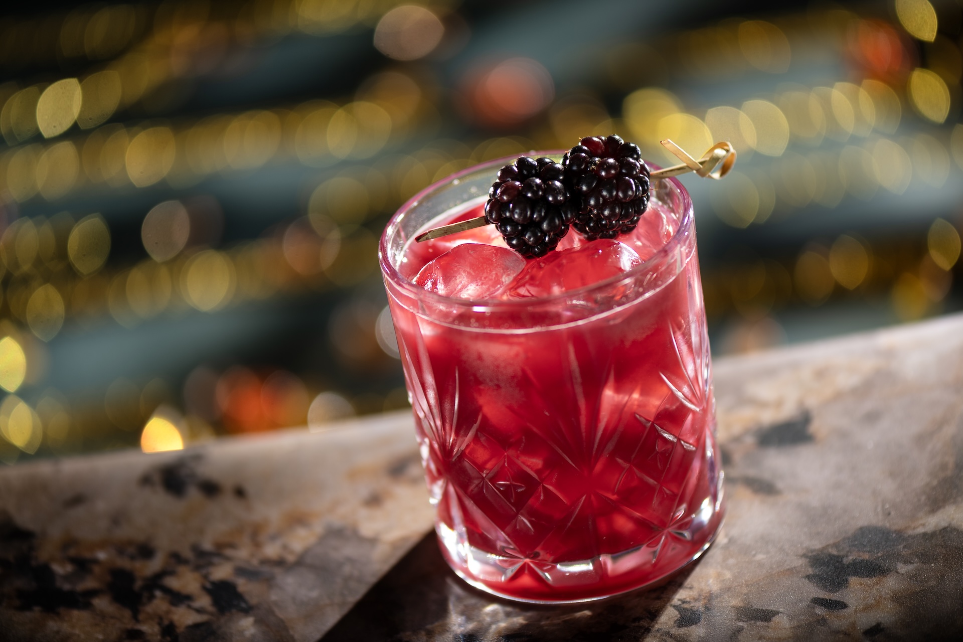promotional image of blackberry bramble style cocktail