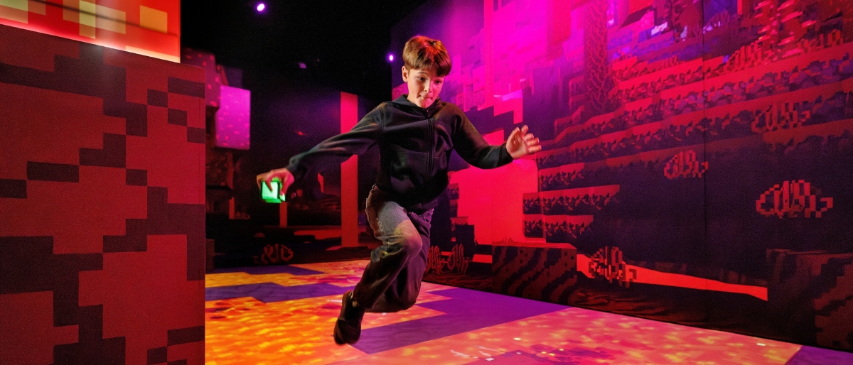 promotional photo of kid inside Minecraft Experience: Villager Rescue: orb in hand.
