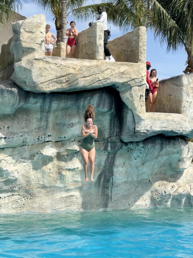 a woman plunges from NCL Great Tides Water Park - Cliffside Leap
