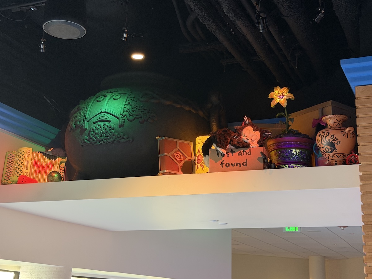 From left to right: Bolt's toy carrot, Mirabel's accordion, Map of Treasure Planet, The Black Cauldron, The Sheperd's Journal from Atlantis , Tangled Lantern, Minnie's cat Figaro, Microbot from Big Hero 6, Sundrop Flower from Tangled, a vase from Hercules 