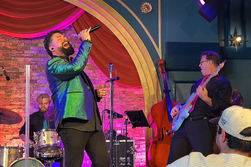 Velvet Neon performs on stage at Hurly-Burly Disney's BoardWalk 