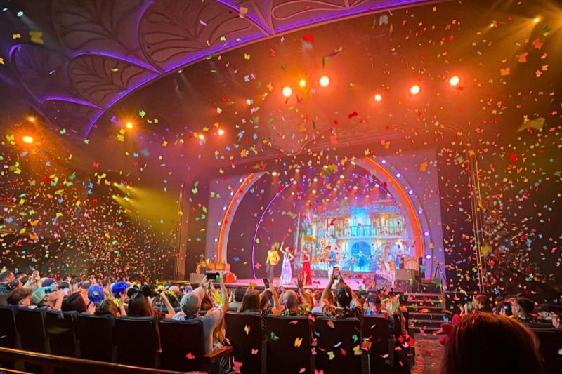 Encanto performance inside Walt Disney Theater during Disney Believe reveal cruise with butterfly shaped confetti