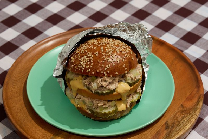 tuna burger on a blue plate for cookbook promotion