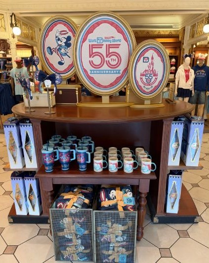 Walt Disney World 55th anniversary merchandise display at Magic Kingdom.
